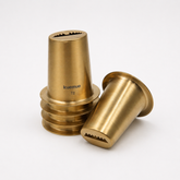 Two brass-colored metal components with 'kuemue' branding on a white background