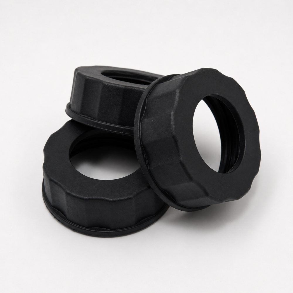 Three black plastic washers stacked on a white background